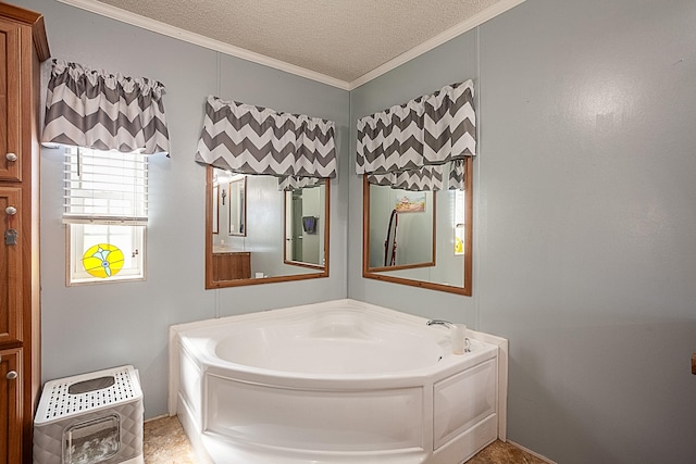 bathroom featuring ornamental molding, a textured ceiling, heating unit, and a tub