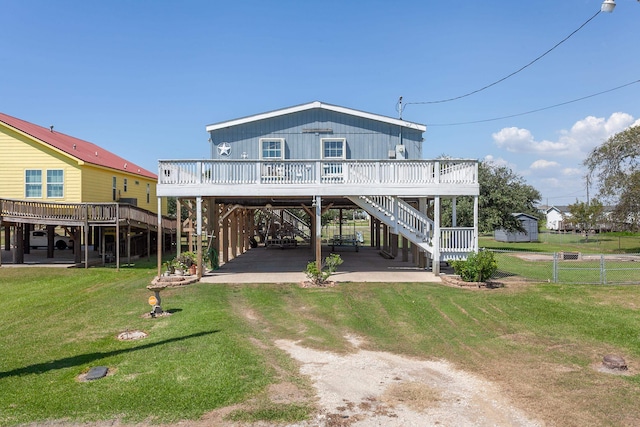 back of house with a patio area, a yard, and a deck