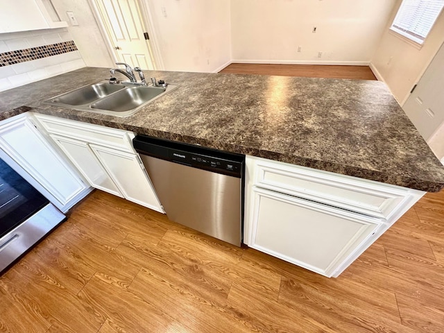 kitchen with tasteful backsplash, stainless steel dishwasher, sink, light hardwood / wood-style flooring, and white cabinetry