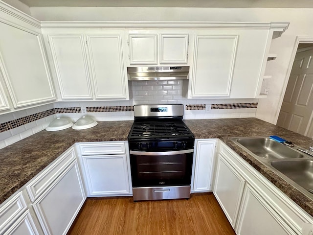 kitchen with white cabinets, tasteful backsplash, hardwood / wood-style floors, and stainless steel gas range