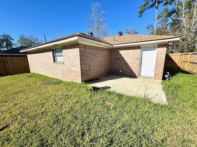 rear view of property with a patio area and a yard