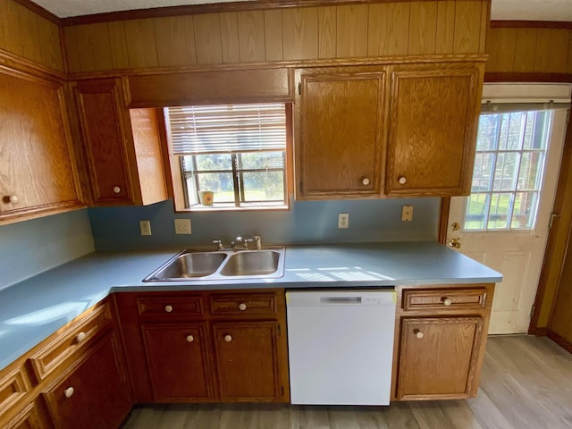 1113 Railroad, Silsbee, TX 77656 - kitchen with dishwasher, a sink, light wood-style floors, light countertops, and brown cabinets