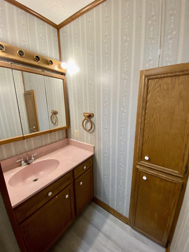 1113 Railroad, Silsbee, TX 77656 - bathroom featuring vanity, wood finished floors, and wallpapered walls