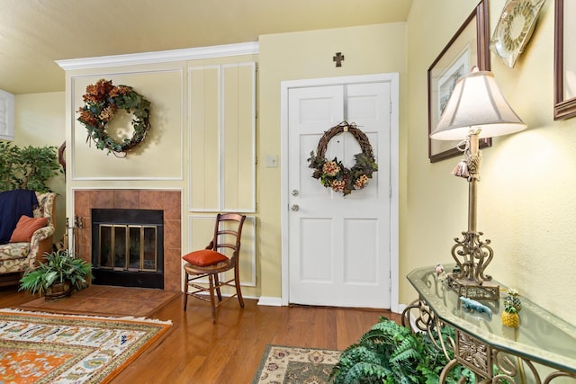 entryway with hardwood / wood-style flooring and a fireplace