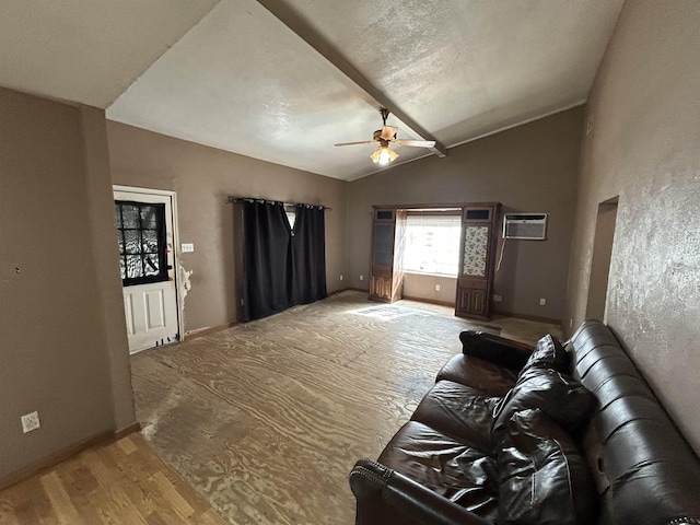 living room featuring lofted ceiling, an AC wall unit, light hardwood / wood-style flooring, ceiling fan, and a textured ceiling