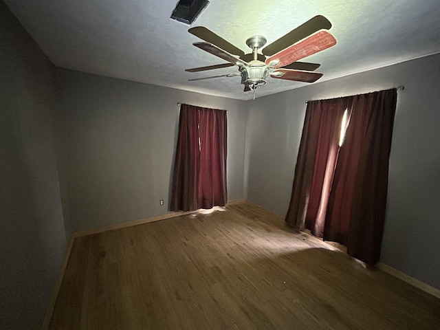 empty room with wood-type flooring and ceiling fan