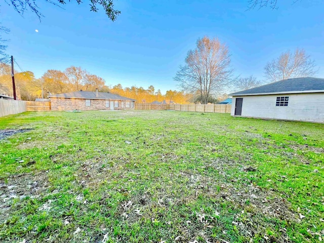 view of yard with a fenced backyard