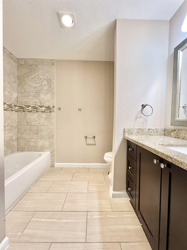 full bath featuring baseboards, toilet, vanity, and a textured ceiling