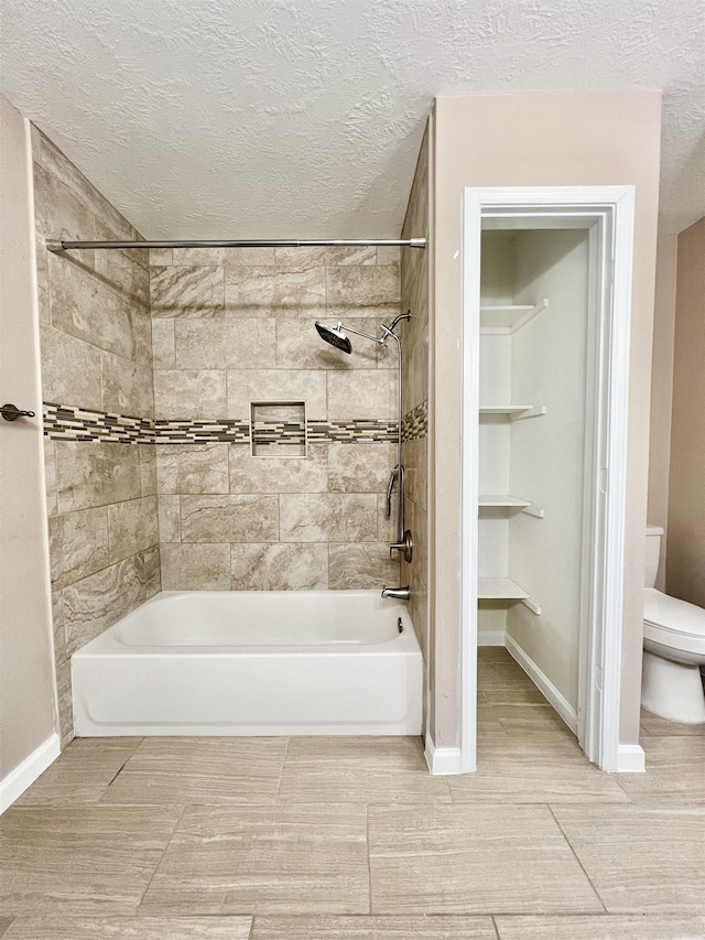 full bath with baseboards, toilet, shower / bathtub combination, and a textured ceiling