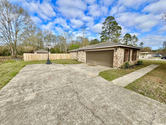 view of property exterior featuring fence, an attached garage, concrete driveway, a lawn, and brick siding