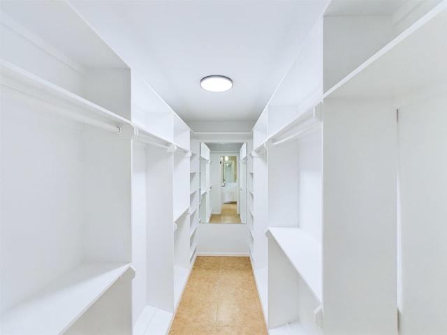 walk in closet with light tile patterned flooring