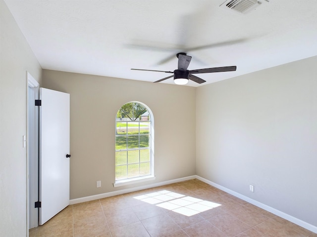 unfurnished room featuring light tile patterned floors and ceiling fan