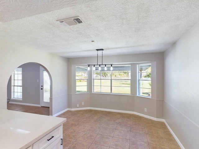 unfurnished dining area featuring light tile patterned floors