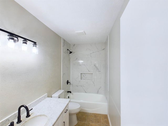 full bathroom with vanity, toilet, and tiled shower / bath