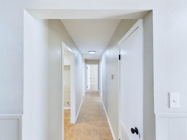 corridor with light tile patterned floors