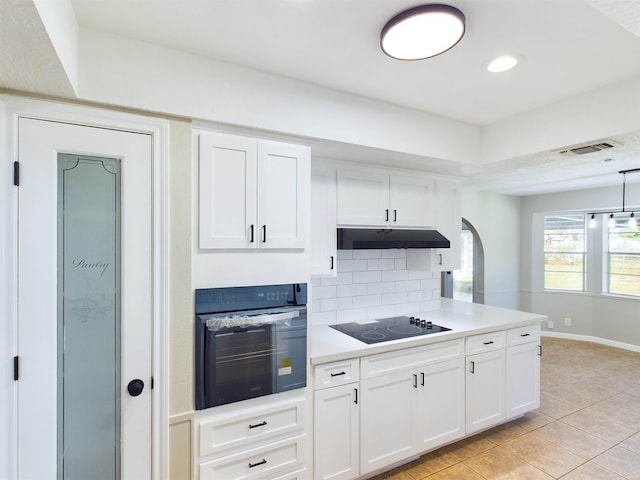 kitchen with backsplash, white cabinetry, light tile patterned floors, and black appliances