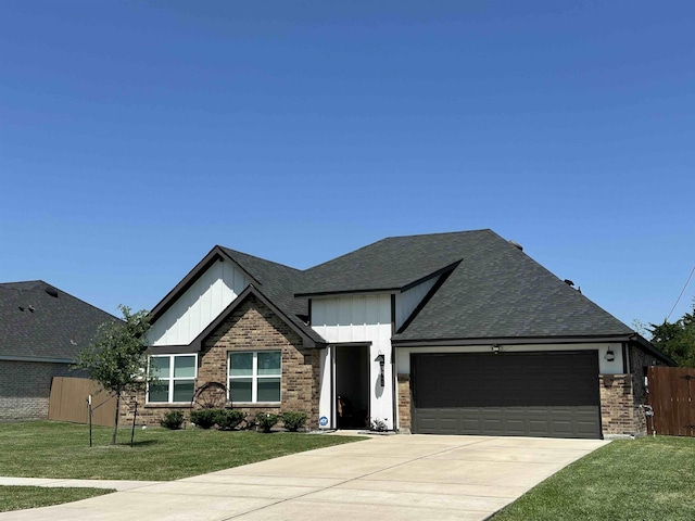 3040 Allie Payne, Orange, TX 77632 - view of front of home with an attached garage, board and batten siding, fence, a front lawn, and driveway