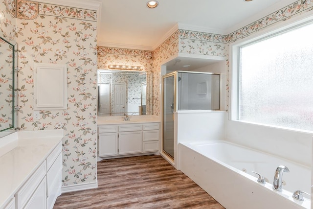 bathroom with hardwood / wood-style flooring, a wealth of natural light, and independent shower and bath