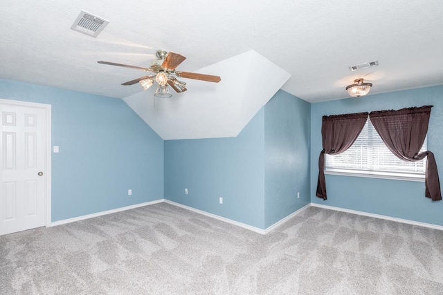 bonus room featuring light carpet, a textured ceiling, ceiling fan, and lofted ceiling