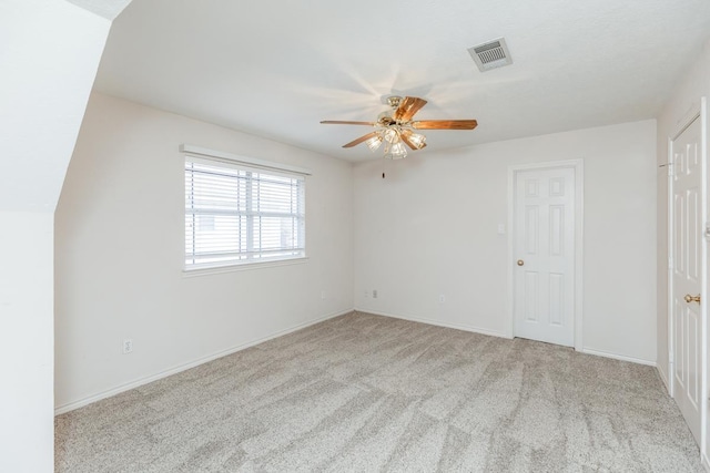 unfurnished bedroom featuring light carpet, a closet, and ceiling fan