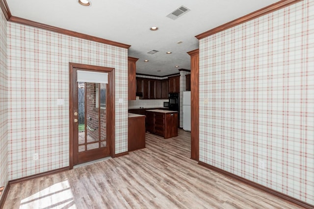 kitchen with light hardwood / wood-style floors and ornamental molding