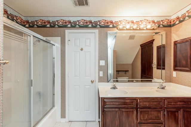 bathroom with tile patterned floors, vanity, and shower / bath combination with glass door