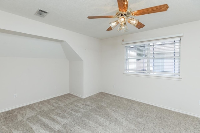 additional living space with light carpet and ceiling fan