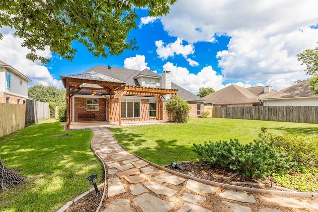 rear view of house featuring a pergola, a patio area, and a lawn