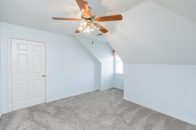 additional living space featuring light carpet, vaulted ceiling, and ceiling fan