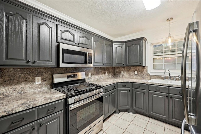 kitchen with a sink, stainless steel appliances, gray cabinets, ornamental molding, and light tile patterned floors