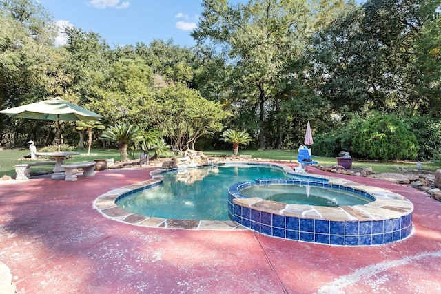 view of pool with a patio area and an in ground hot tub