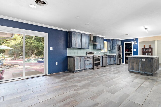 kitchen featuring tasteful backsplash, crown molding, wall chimney range hood, and appliances with stainless steel finishes