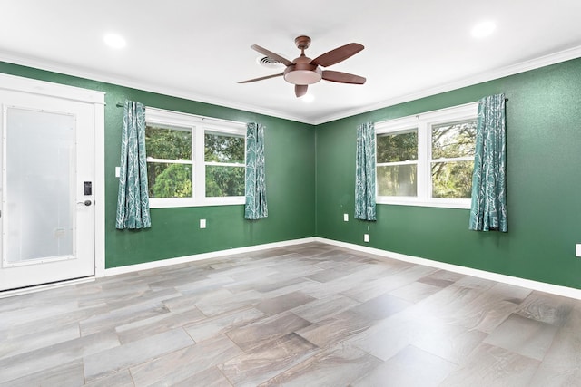 unfurnished room with ceiling fan and ornamental molding