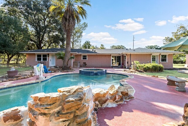 view of swimming pool with an in ground hot tub and a patio