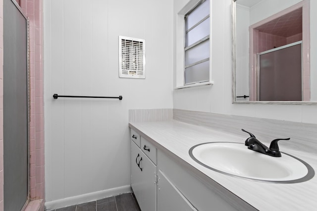 bathroom with vanity and a shower with shower door