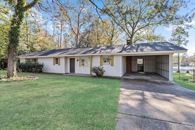 ranch-style house with a carport, a porch, a water view, and a front lawn