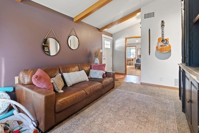 living room with lofted ceiling with beams and light colored carpet