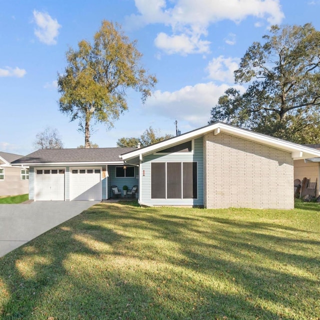 ranch-style house featuring a garage and a front lawn