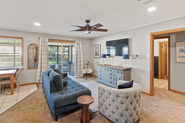 carpeted living room featuring a wealth of natural light, ceiling fan, and ornamental molding