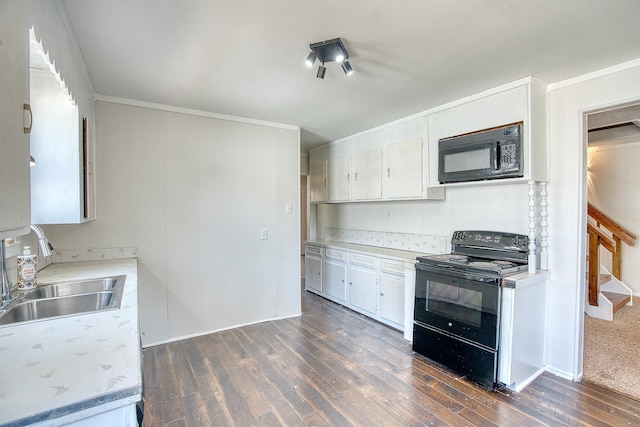kitchen featuring dark wood-style flooring, light countertops, crown molding, black appliances, and a sink