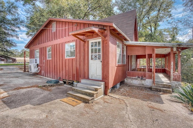 view of outbuilding with entry steps and ac unit