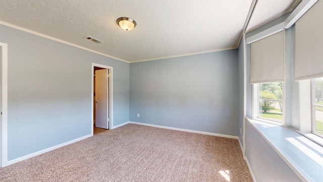 unfurnished room with carpet floors, ornamental molding, baseboards, and a textured ceiling
