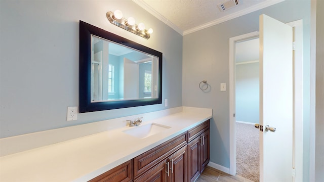 bathroom featuring crown molding, vanity, and baseboards