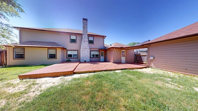 rear view of house with a wooden deck and a chimney