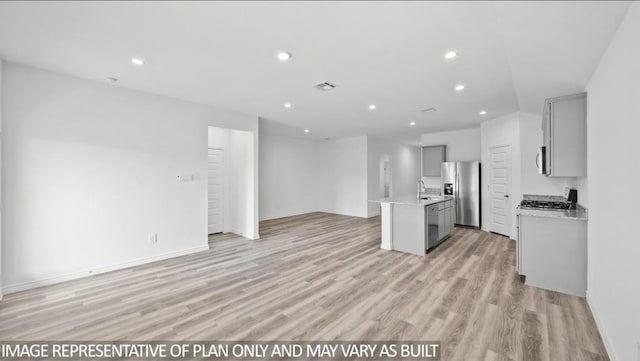 1725 Holly Trl, Sour Lake, TX 77659 - kitchen featuring appliances with stainless steel finishes, gray cabinets, open floor plan, light countertops, and recessed lighting