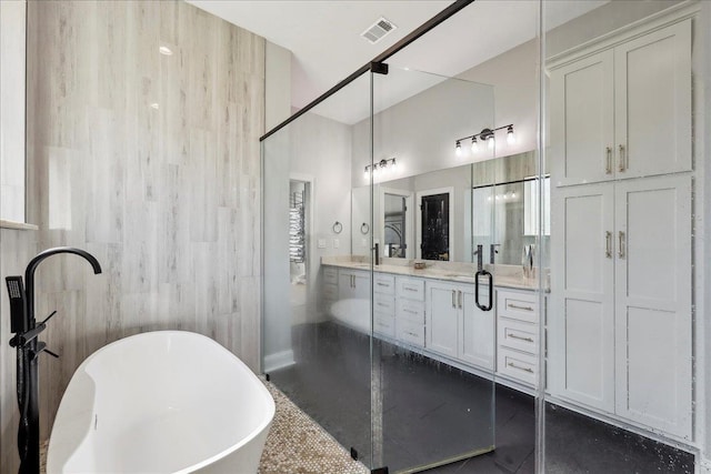 bathroom with double vanity, visible vents, a soaking tub, tile patterned flooring, and walk in shower