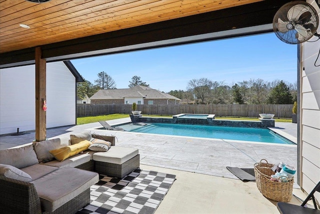 view of swimming pool with a pool with connected hot tub, a fenced backyard, and a patio