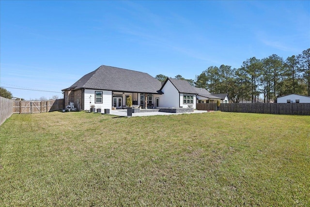 back of property featuring a patio area, a fenced backyard, and a yard