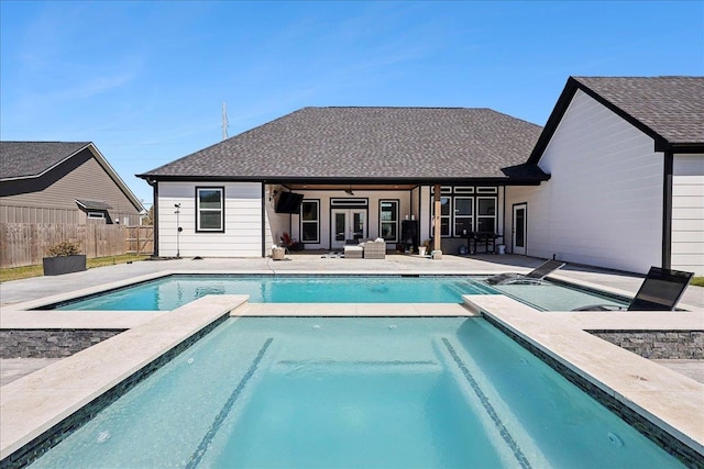 view of pool featuring a fenced in pool, fence, a patio, and an in ground hot tub