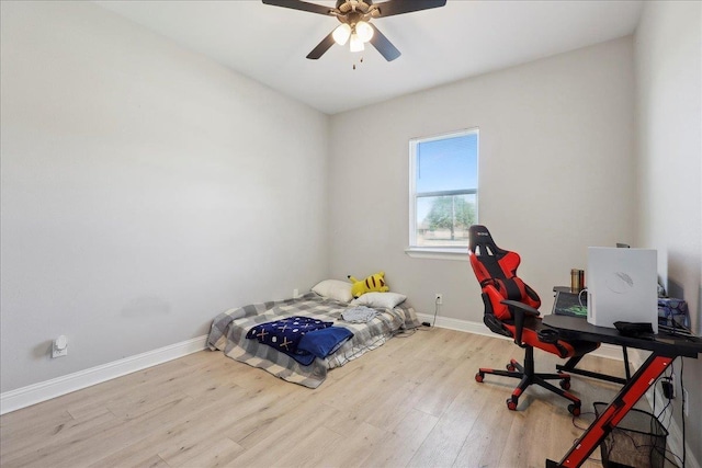 unfurnished bedroom with ceiling fan, baseboards, and wood finished floors